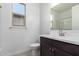 Bright bathroom showcasing a sink, toilet, mirror, and window at 11408 S 50Th Ln, Laveen, AZ 85339