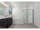 Bright bathroom showcasing a double vanity, soaking tub, and glass-enclosed shower at 11408 S 50Th Ln, Laveen, AZ 85339