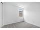 Bright bedroom featuring neutral carpet, baseboards, paint, and window at 11408 S 50Th Ln, Laveen, AZ 85339