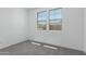 Bright bedroom featuring neutral carpet, baseboards, paint, and two windows at 11408 S 50Th Ln, Laveen, AZ 85339