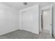 Bedroom featuring a double door closet, carpet, baseboards, and paint at 11408 S 50Th Ln, Laveen, AZ 85339