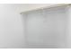 Bright white walk-in closet with wood rod ready for storage and organization at 11408 S 50Th Ln, Laveen, AZ 85339
