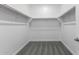 Walk-in closet features shelving units, and carpet, offering organized storage solutions at 11408 S 50Th Ln, Laveen, AZ 85339