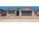 Charming single-story home featuring a two-car garage, desert landscaping, and a neutral color palette at 11408 S 50Th Ln, Laveen, AZ 85339