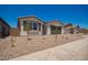 Charming single-story home with a low-maintenance desert rock front yard and a two-car garage at 11408 S 50Th Ln, Laveen, AZ 85339