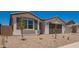Charming single story home with desert rock landscaping, covered entry and two-car garage at 11408 S 50Th Ln, Laveen, AZ 85339