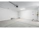 Spacious two car garage with concrete flooring and white walls at 11408 S 50Th Ln, Laveen, AZ 85339