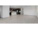 Bright, open-concept layout showcasing tile floors and a modern kitchen with stainless steel appliances at 11408 S 50Th Ln, Laveen, AZ 85339
