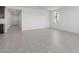 The living room features bright white walls and neutral-colored tile flooring throughout at 11408 S 50Th Ln, Laveen, AZ 85339