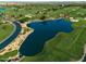 Soar above this golf course community, revealing a landscape of pristine greens, water features, and luxury homes at 116 E Santa Lucia Ln, Queen Creek, AZ 85140