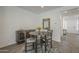 Dining area featuring a table for four, stylish cabinet, decor, and access to other rooms at 116 E Santa Lucia Ln, Queen Creek, AZ 85140