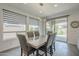 Elegant dining area with a modern light fixture and sliding glass doors that provide natural light and access to the outside at 116 E Santa Lucia Ln, Queen Creek, AZ 85140