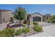 Charming single-story home showcasing desert landscaping, a two-car garage and manicured foliage at 116 E Santa Lucia Ln, Queen Creek, AZ 85140