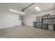 Spacious garage equipped with ample storage cabinets, a workbench, and lots of room for vehicles at 116 E Santa Lucia Ln, Queen Creek, AZ 85140