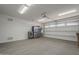 Spacious two car garage featuring white walls, gray epoxy floors, and bright overhead lighting at 116 E Santa Lucia Ln, Queen Creek, AZ 85140