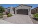 Beautiful home featuring a spacious driveway with a two-car garage and well-maintained landscaping at 116 E Santa Lucia Ln, Queen Creek, AZ 85140