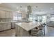 Modern kitchen with stainless steel appliances, a large center island, and stylish pendant lighting at 116 E Santa Lucia Ln, Queen Creek, AZ 85140