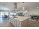 Spacious kitchen featuring an oversized island, stainless steel appliances, and an open layout to the dining and living areas at 116 E Santa Lucia Ln, Queen Creek, AZ 85140