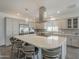 Bright kitchen showcasing a large island with seating, stainless steel appliances, and ample cabinetry at 116 E Santa Lucia Ln, Queen Creek, AZ 85140