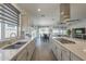 Stylish kitchen featuring a large island, stainless steel appliances, and access to the outdoor patio at 116 E Santa Lucia Ln, Queen Creek, AZ 85140