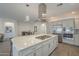 Bright, open kitchen with a large island, stainless steel appliances, and stylish pendant lighting at 116 E Santa Lucia Ln, Queen Creek, AZ 85140