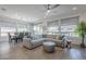 Spacious living area with tile floors, lots of natural light, and comfortable sectional sofa at 116 E Santa Lucia Ln, Queen Creek, AZ 85140