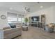 Cozy living room with a modern fireplace, built-in shelving, tile floors, and comfortable seating at 116 E Santa Lucia Ln, Queen Creek, AZ 85140