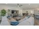 Cozy living room featuring a sectional sofa, built-in shelving, modern fireplace, and access to dining area at 116 E Santa Lucia Ln, Queen Creek, AZ 85140