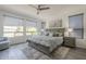 Comfortable main bedroom with wide windows allowing natural light and finished with wood-look tile at 116 E Santa Lucia Ln, Queen Creek, AZ 85140