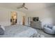 Neutral tone main bedroom with tile floors and a full dresser, with bathroom and closet access at 116 E Santa Lucia Ln, Queen Creek, AZ 85140