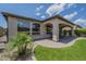 Inviting covered patio with brick flooring and an outdoor dining area, perfect for entertaining guests or enjoying a quiet evening at 116 E Santa Lucia Ln, Queen Creek, AZ 85140