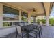 Covered patio featuring tile floors, ceiling fan, and a large, comfortable table and chairs at 116 E Santa Lucia Ln, Queen Creek, AZ 85140