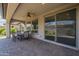 Enjoy this covered patio with a ceiling fan, large windows, and access to the outdoors at 116 E Santa Lucia Ln, Queen Creek, AZ 85140