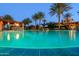 Inviting community pool with palm trees and shaded seating areas at 116 E Santa Lucia Ln, Queen Creek, AZ 85140
