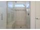 Luxurious glass enclosed shower with mosaic tile accents, a built-in seat, and modern hardware at 116 E Santa Lucia Ln, Queen Creek, AZ 85140