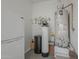 Utility area with water heater, water softener, and additional storage; features a vintage Crosley refrigerator at 116 E Santa Lucia Ln, Queen Creek, AZ 85140