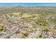Aerial view showcasing a vibrant neighborhood, school, and surrounding mountain views at 11875 W Lone Tree Trl, Peoria, AZ 85383