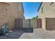 View of backyard fence separating gravel landscaped yards on a sunny day at 11875 W Lone Tree Trl, Peoria, AZ 85383