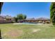 Beautiful backyard featuring a lush lawn and a sparkling blue swimming pool, great for outdoor enjoyment at 11875 W Lone Tree Trl, Peoria, AZ 85383