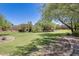Expansive backyard featuring lush green grass, mature trees, and a serene landscape design at 11875 W Lone Tree Trl, Peoria, AZ 85383