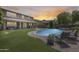 Backyard with a pool, lounge chairs, and lush green landscaping at 11875 W Lone Tree Trl, Peoria, AZ 85383