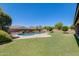 Expansive backyard features a refreshing pool, manicured lawn, and lush landscaping, creating a private oasis at 11875 W Lone Tree Trl, Peoria, AZ 85383