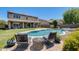 Backyard featuring a stunning pool, comfortable lounge chairs, and a well-maintained lawn under a clear blue sky at 11875 W Lone Tree Trl, Peoria, AZ 85383