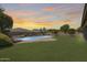 Expansive backyard featuring a lush lawn and a custom pool, offering ample space for recreation and outdoor activities at 11875 W Lone Tree Trl, Peoria, AZ 85383