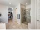 Bathroom featuring a walk-in shower, walk-in closet, and tile floor at 11875 W Lone Tree Trl, Peoria, AZ 85383