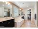 A luxurious bathroom showcasing a soaking tub, double vanities, and a walk-in closet at 11875 W Lone Tree Trl, Peoria, AZ 85383
