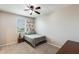 Cozy bedroom featuring carpet, a window, a floral wall chart and side table at 11875 W Lone Tree Trl, Peoria, AZ 85383