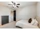 This bedroom has carpet floors, a ceiling fan, and a dresser near the closet at 11875 W Lone Tree Trl, Peoria, AZ 85383