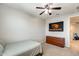 Inviting bedroom with ceiling fan, carpet flooring and bureau for ample storage at 11875 W Lone Tree Trl, Peoria, AZ 85383