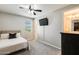 This bedroom has carpet floors, a ceiling fan, and a television mounted on the wall at 11875 W Lone Tree Trl, Peoria, AZ 85383